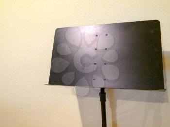 Sheet Music stand black color metal against white wall