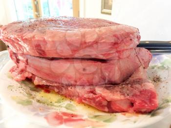 beef steak on plate outdoor ready to cook