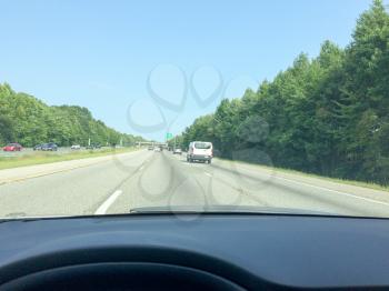Higway driving on sunny day in car view outdoors