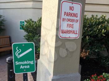 Outddor smoking area designated with benches and flower bed