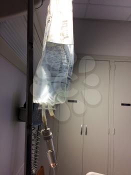 iv intravenous drip attached to solution medicine plastic bag
