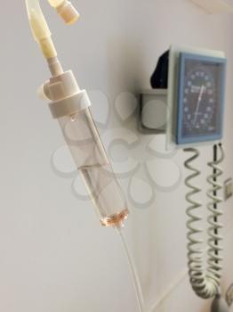 iv intravenous drip attached to solution and blood pressure guage