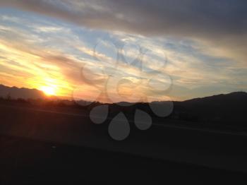amazing sunset sunrise over mountain while freeway driving