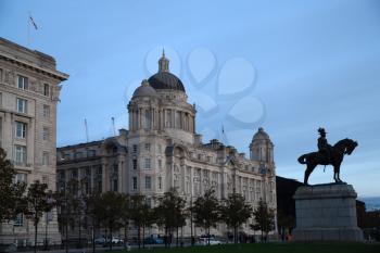 Liverpool, UK - 19 October 2019: Port of liverpool building and statue of Edward VII at dusk