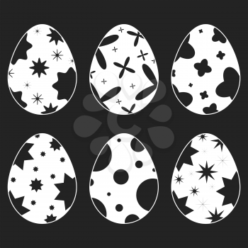 Set of white isolated silhouettes of Easter eggs on a black background. With an abstract pattern. Simple flat vector illustration. Suitable for decoration of postcards, advertising, magazines, websites.