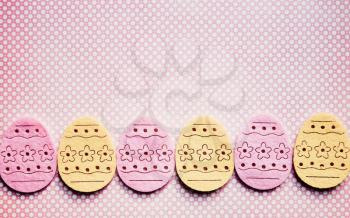 old style decorated felt easter eggs on a  polka dots background with a intentional vignetting and frame