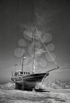 Old abandoned ship in a land in black and white