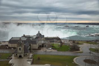 View of the horseshoe falls from canadian border and welcome center building at Niagara falls during winter season