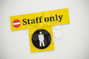 A staff only sign on a white background.