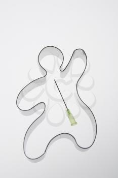 Gingerbread cookie cutter with a needle tip in the middle.