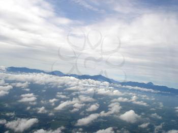 Royalty Free Photo of Clouds and Water With Mountains in the Distance