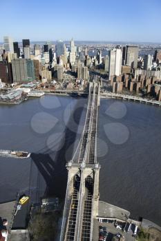 Aerial view of Brooklyn Bridge with East River and Manhattan buildings in New York City.