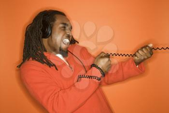 Royalty Free Photo of a Man Pulling on a Cord Wearing Headphones
