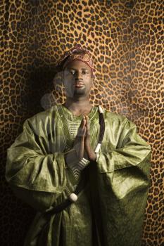 Royalty Free Photo of an African-American Man in Prayer Wearing traditional African Clothing