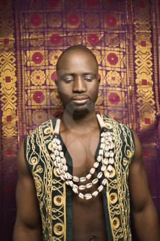 Royalty Free Photo of an African-American Man Wearing an Embroidered African Vest and Beads
