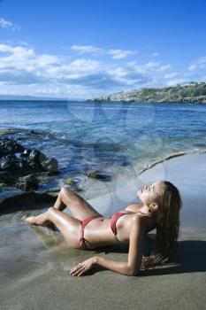 Royalty Free Photo of a Young Female Lying on a Beach in a Bikini in Maui Hawaii