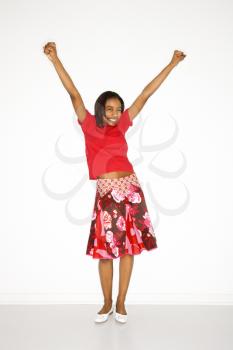 Royalty Free Photo of a Teen Girl With Her Arms Raised