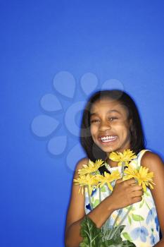 Royalty Free Photo of a Teen Girl Holding a Bouquet of Daisies