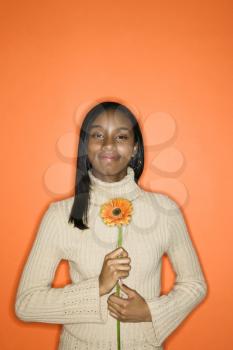Royalty Free Photo of a Teen Girl Holding a Daisy