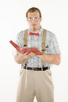 Royalty Free Photo of a Young Man Dressed Like a Nerd With a Book Open 