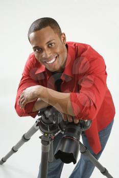 Royalty Free Photo of a Young African American Male Photographer Posing in a Studio