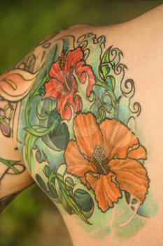 Royalty Free Photo of a Close-up of a Floral Tattoo on a Woman's Shoulder