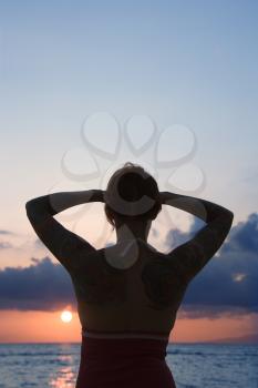 Royalty Free Photo of a Tattooed Woman on a Beach at Sunset in Maui, Hawaii, USA