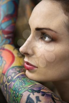 Royalty Free Photo of a Close-up of an Attractive Woman's Face and Tattooed Arm