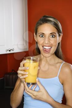 Royalty Free Photo of a Woman Holding a Glass of Orange Juice