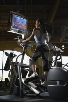 Royalty Free Photo of a Female on an Elliptical Machine at a Gym
