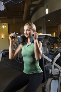 Royalty Free Photo of a Female Using Exercise Equipment at the Gym