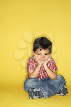 Royalty Free Photo of a Boy Sitting Smiling