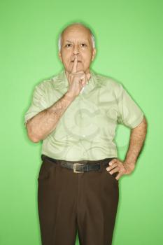 Royalty Free Photo of an Older Male With His Finger Up to His Mouth