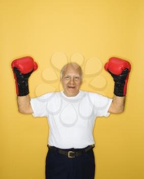 Royalty Free Photo of an Older Man Wearing Boxing Gloves