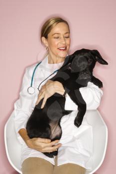 Royalty Free Photo of a Veterinarian Holding a Puppy