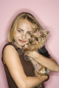 Royalty Free Photo of a Young Female Holding a Yorkshire Terrier Dog