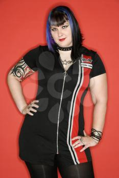 Royalty Free Photo of a Woman with Blue Hair and Tattoos Wearing a Racing Dress 
