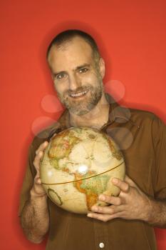 Royalty Free Photo of a Smiling Man Holding a Globe