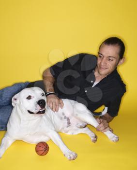 Royalty Free Photo of a Man Lying Down With a Pit Bull