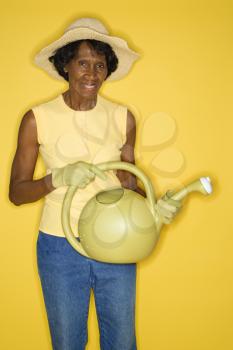 Royalty Free Photo of an Older Woman Holding a Watering Can
