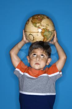 Royalty Free Photo of a Boy Holding a Globe on His Head
