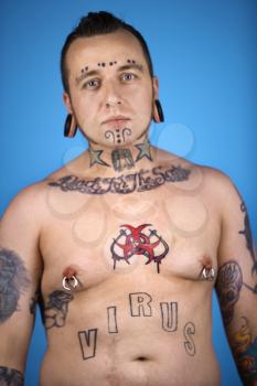Royalty Free Photo of a Shirtless Man With Tattoos and Piercings