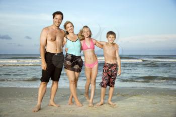 Royalty Free Photo of a Family Standing on a Beach