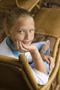 Royalty Free Photo of a Preteen Girl With Chin in Hand Looking at Viewer