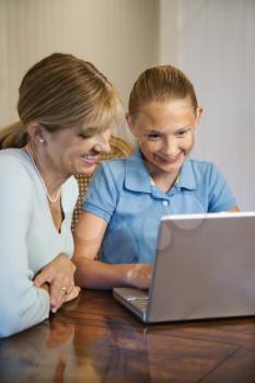 Royalty Free Photo of a Woman and Preteen Girl Using a Laptop Computer
