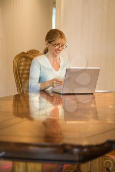 Royalty Free Photo of a Woman Using a Laptop Computer