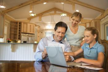 Royalty Free Photo of a Family Paying Bills on a Laptop