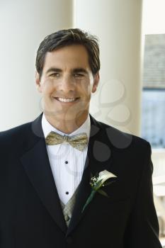 Royalty Free Photo of a Groom in a Tuxedo Smiling