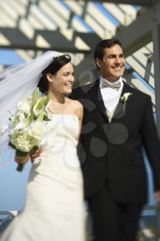 Royalty Free Photo of a Bride and Groom Walking Together Smiling