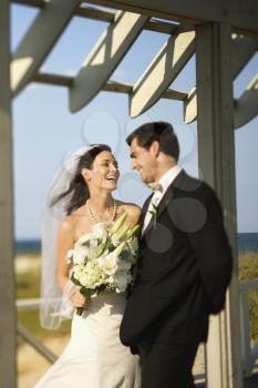 Royalty Free Photo of a Bride and Groom Looking at Each Other Talking and Laughing